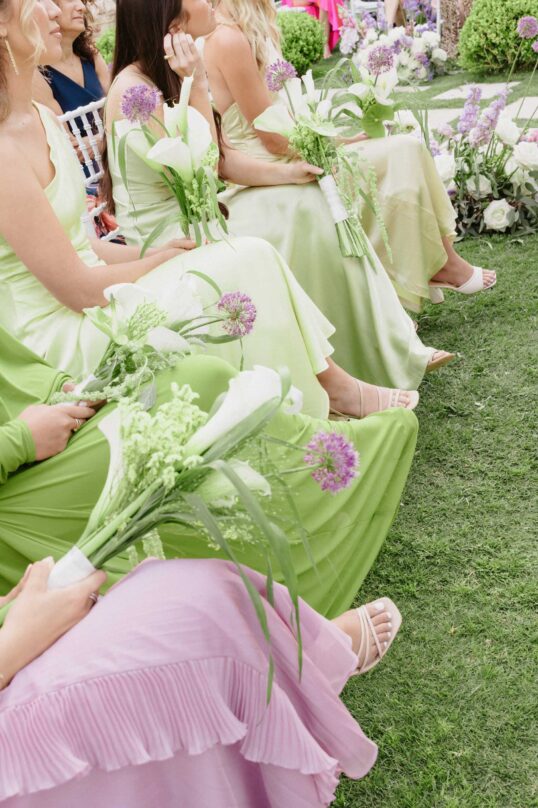 545_JIN_9055 Bridesmaids in pastel dresses during the wedding ceremony at Villa Eva