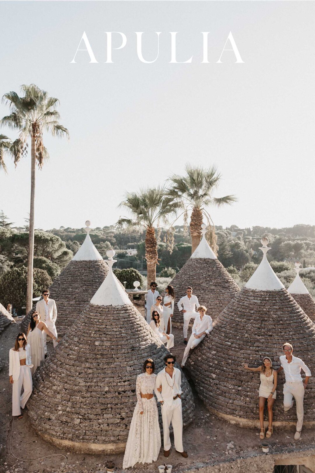 Bride and groom among the trulli during their destination wedding celebration in Puglia